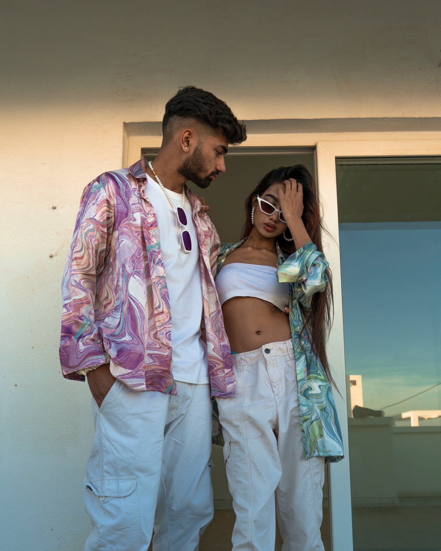 A young lady & men posing in floral shirts