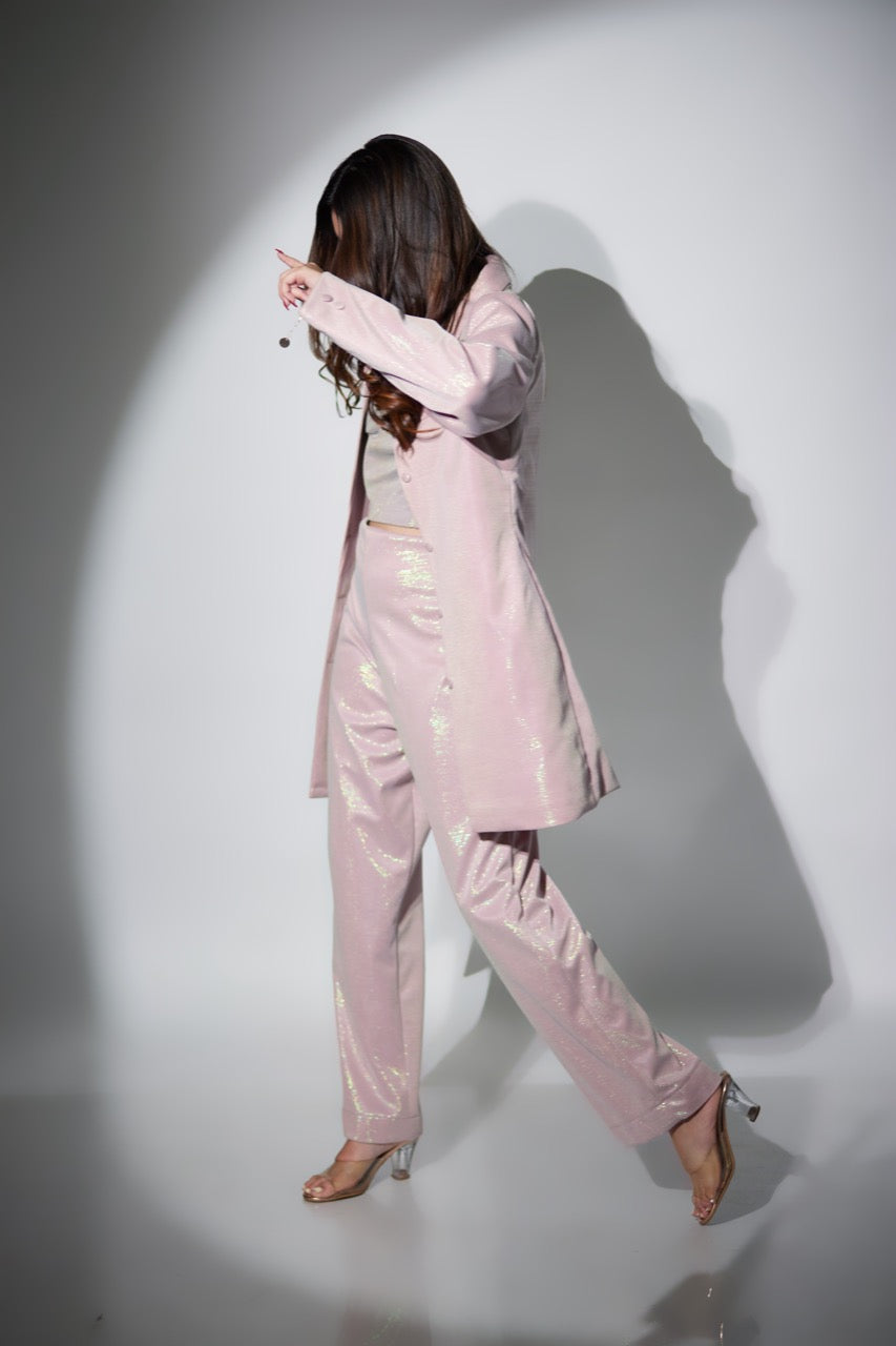 A model posing in pink blazer set dress
